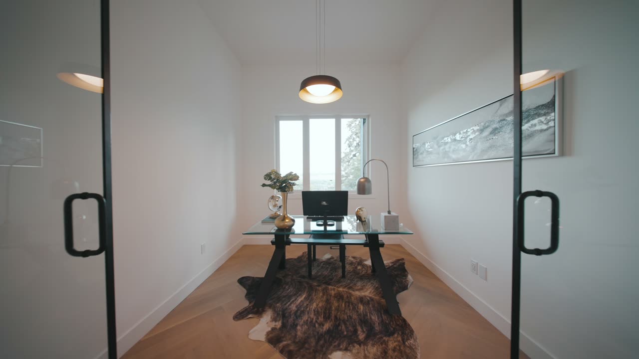 Listing film still: glass doors opening into a home office