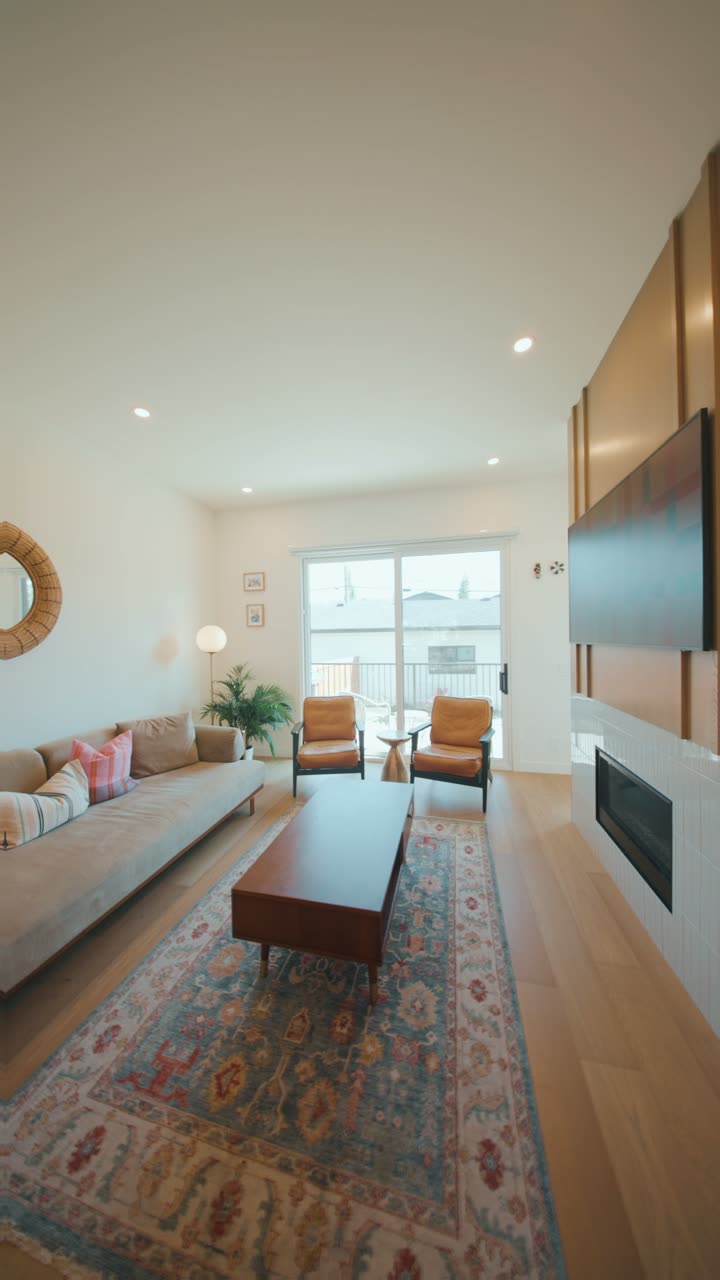 Vertical reel still: living room with a patterned rug and leather chairs