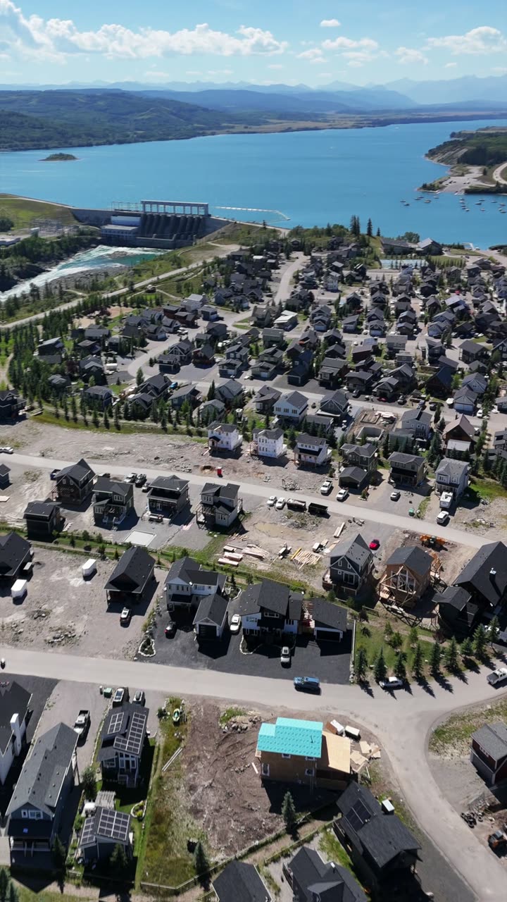 Vertical drone reel still: aerial view of a new lakeside community near Calgary